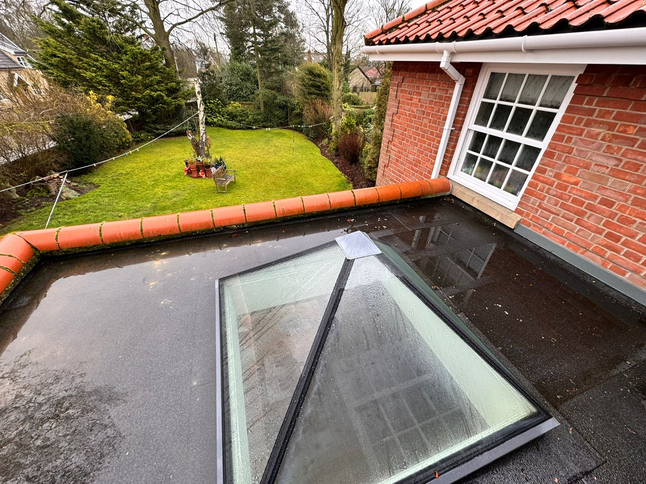 Old flat roof before replacement pooling with water and leaking