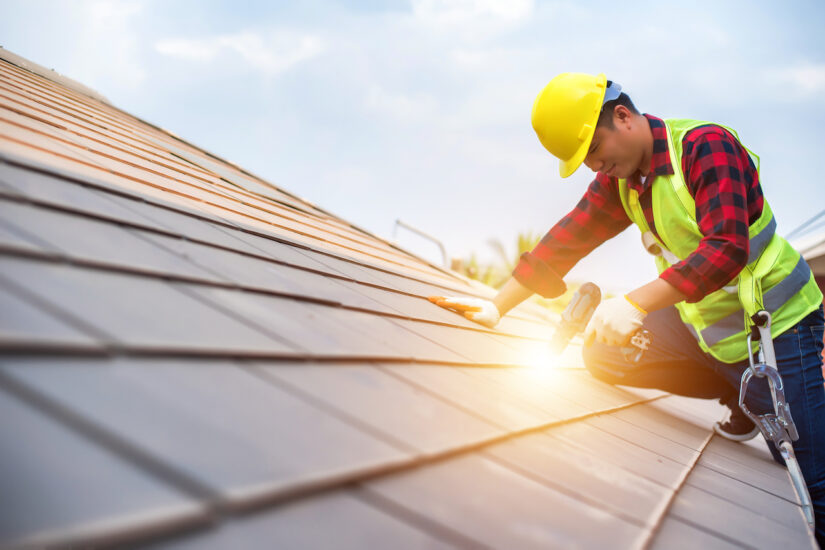 Roofer doing a small repair on a roof
